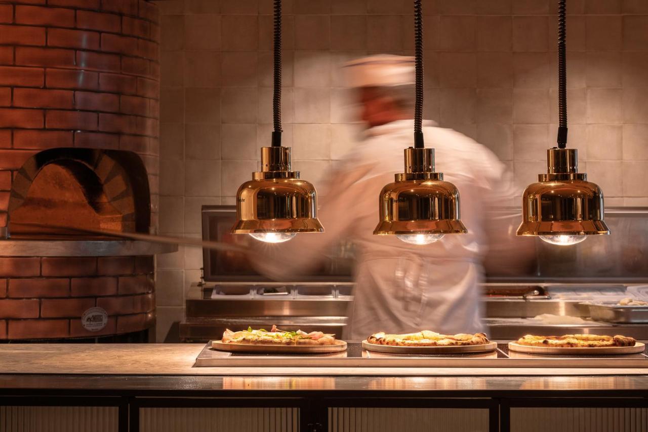 Helea Lifestyle Beach Resort Kallithéa 外观 照片 Pizzas being prepared at a restaurant